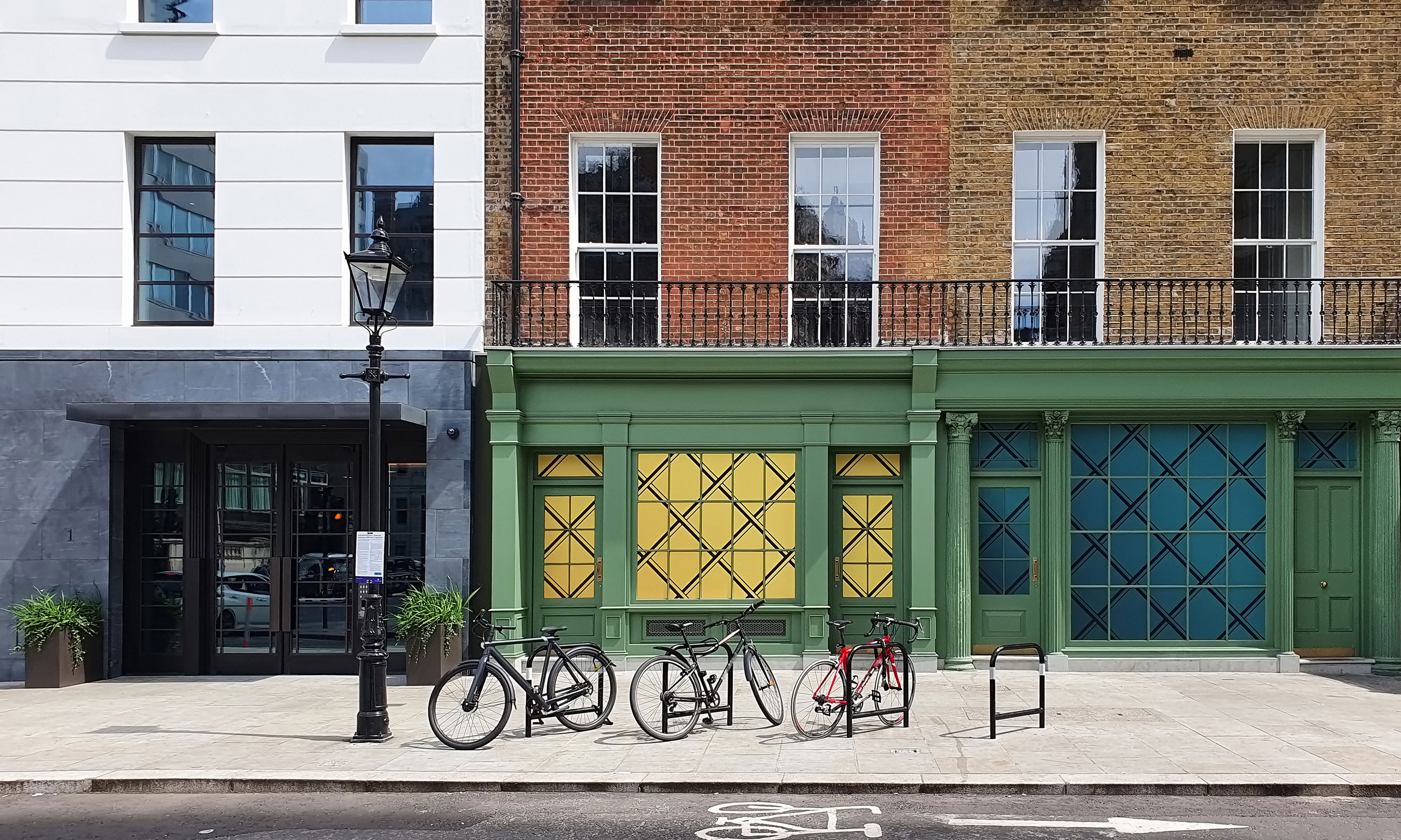 Bicycles On Bike Racks Along Sidewalk In Residential Area