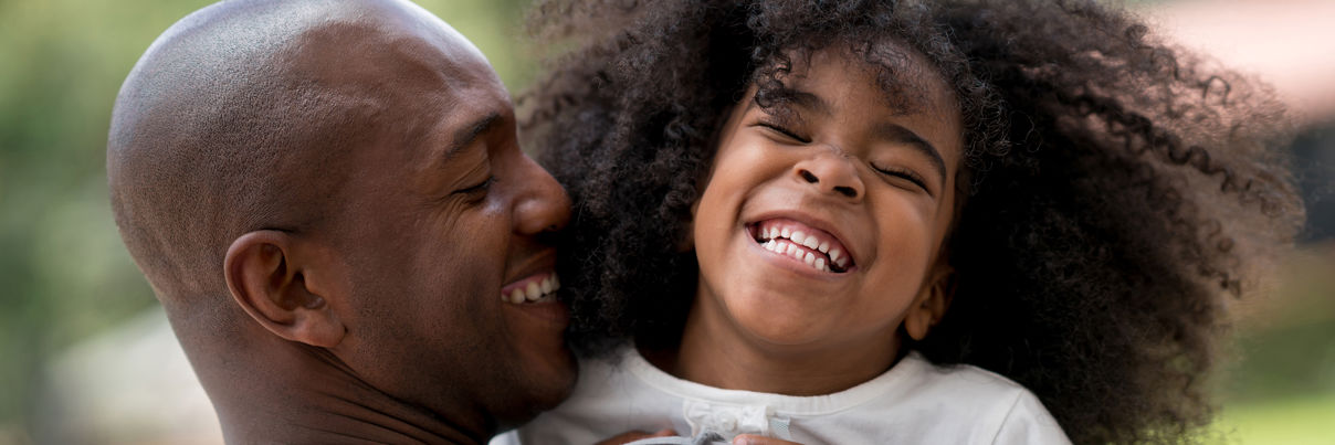 Happy Father Playing With His Daughter Outdoors