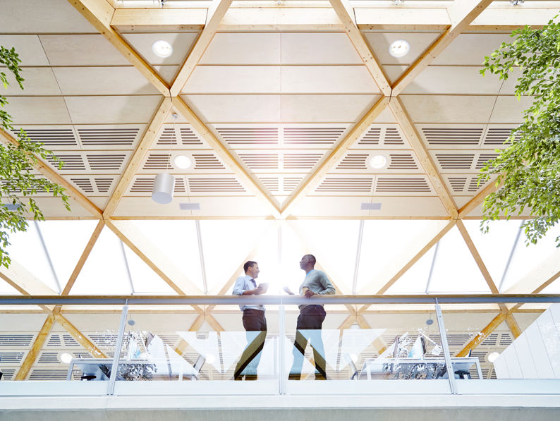 Work colleagues having a catch up in modern office