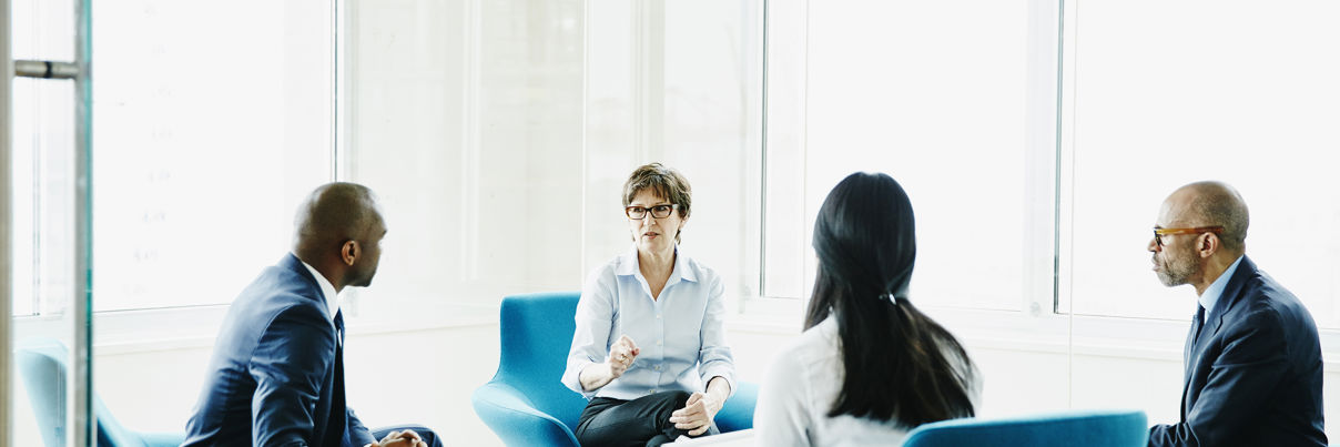 Businesswoman Leading Meeting In Office