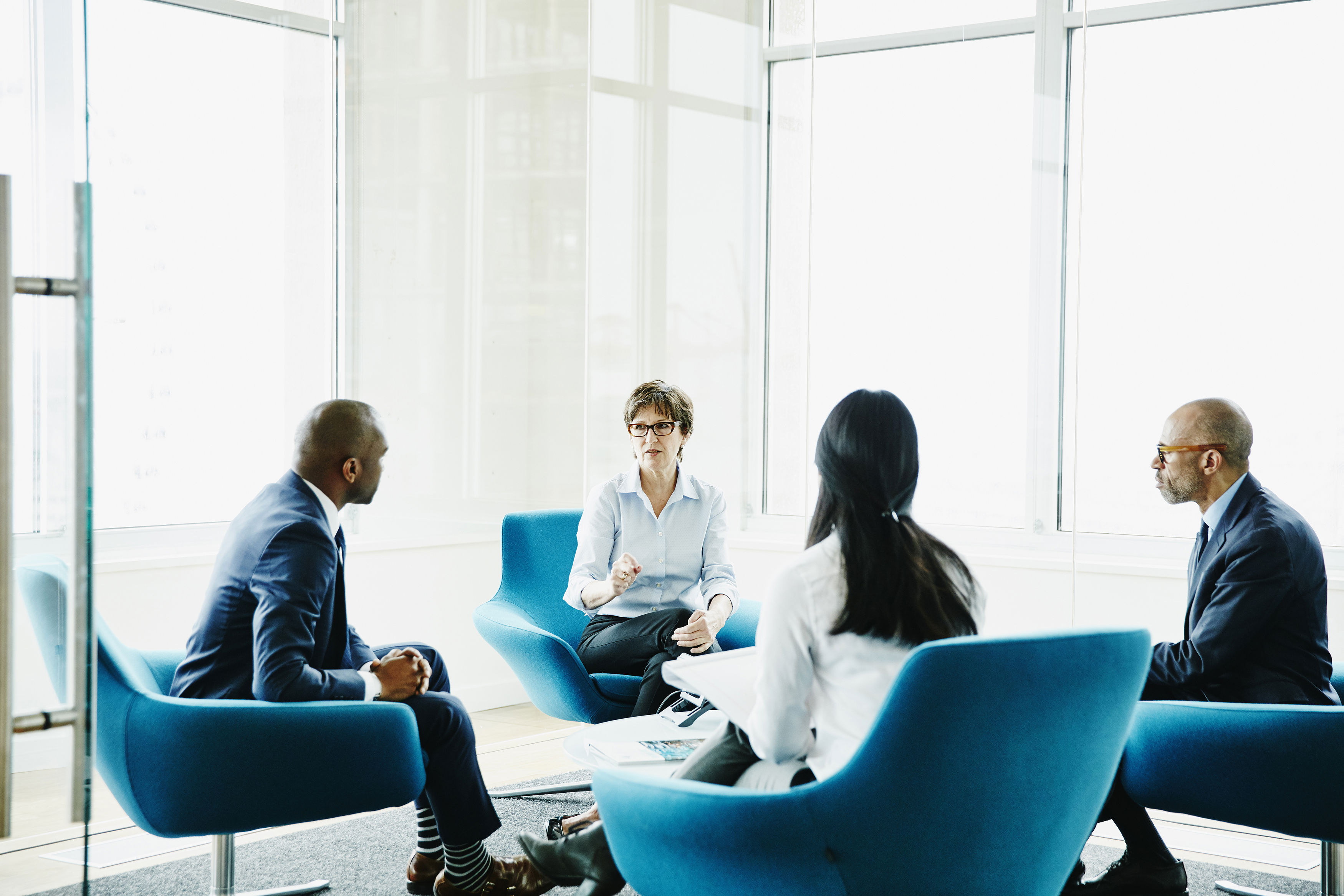 Businesswoman Leading Meeting In Office