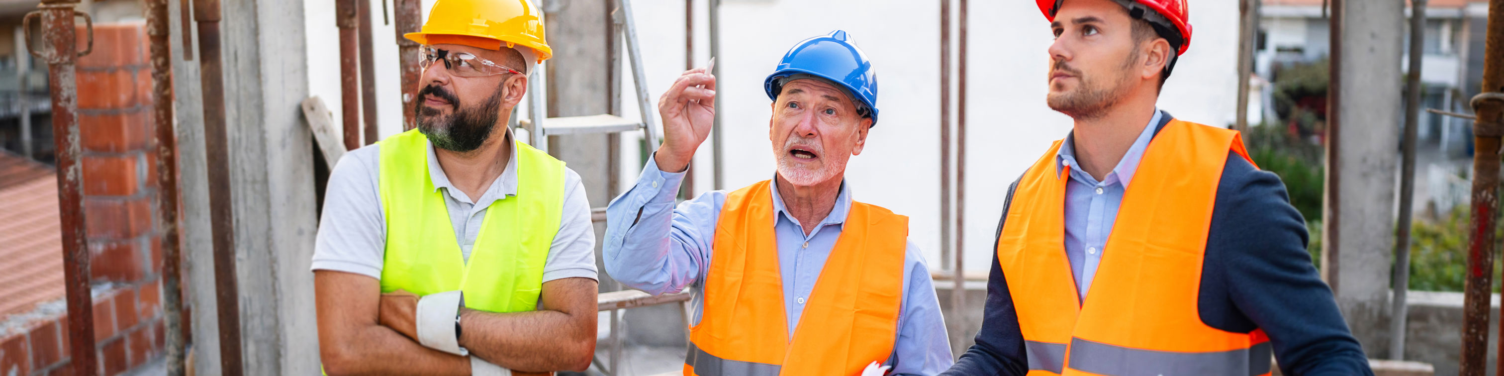 Caucasian Architects Having An Meeting With An Building Contractor, On A Construction Site Stock Photo