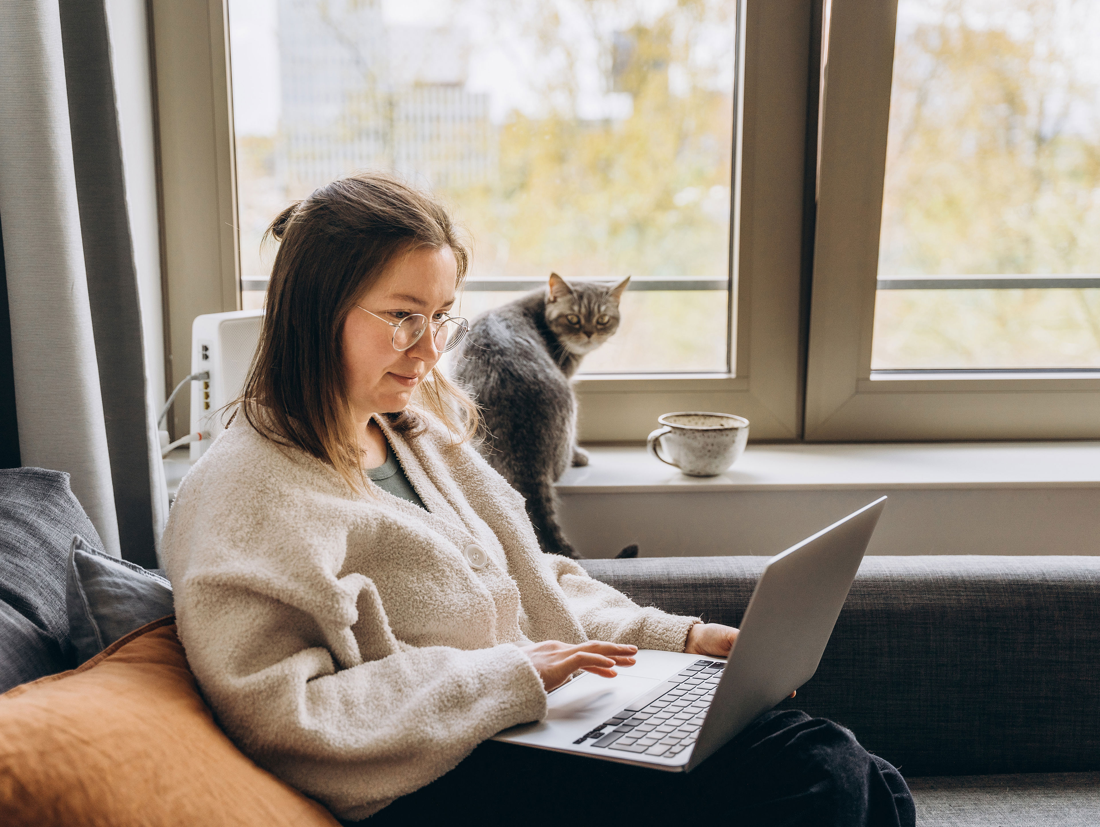 Young Woman Working At Home Remotely Using A Laptop