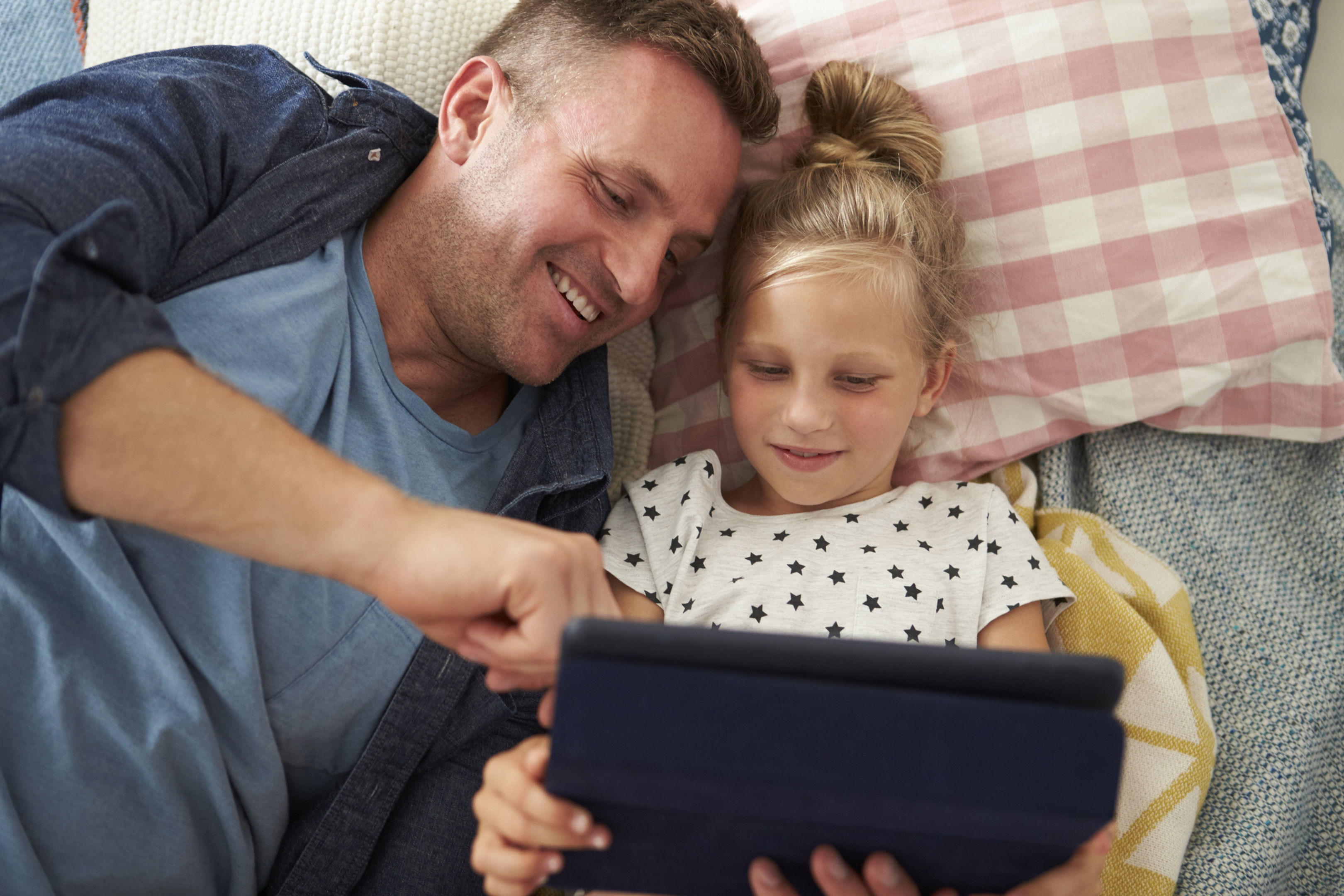 Father And Daughter Looking At Tablet