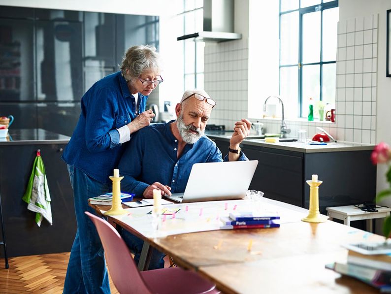 2 Elderly People Looking At Laptop
