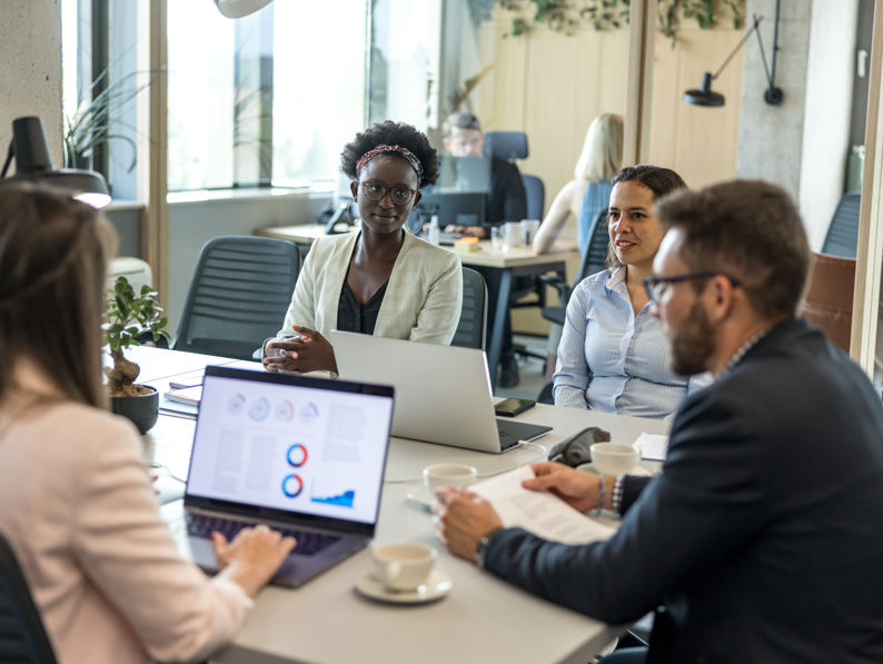 Casual Talk During Office Lunch Hour Between Multiracial Colleagues