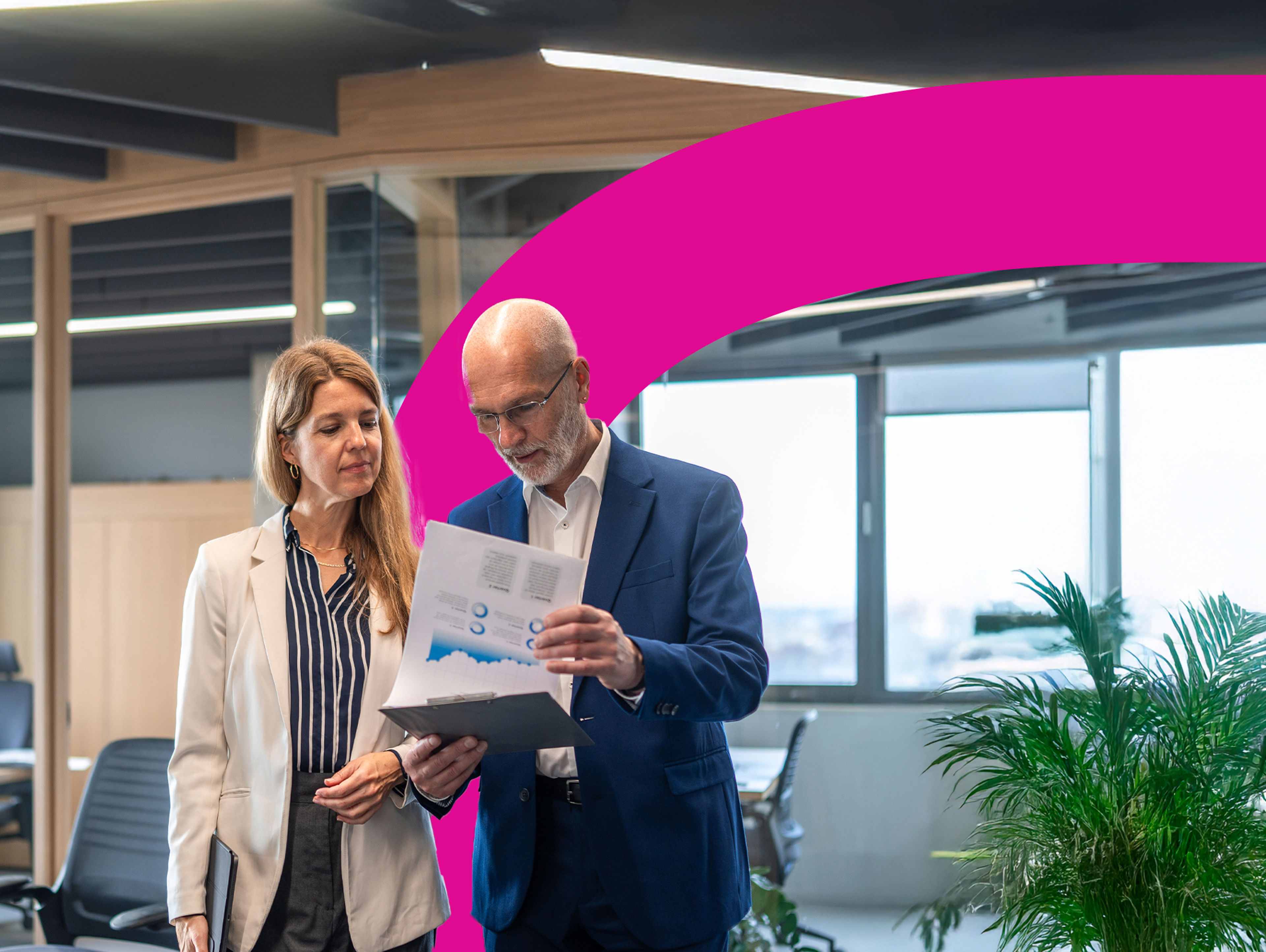 A close-up of a lion’s face and mane, looking directly at the camera with an alert expression. The background is blurred, drawing focus to the lion’s intense eyes and detailed fur.