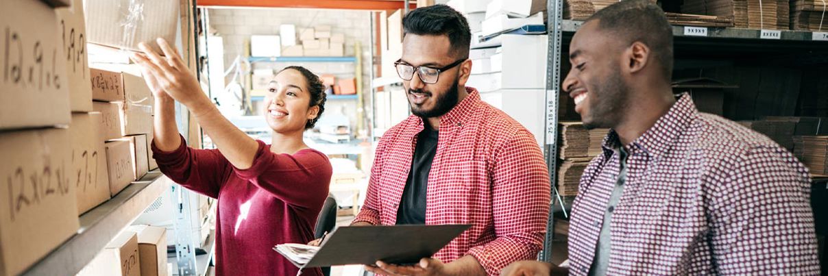 3 People Looking At Boxes