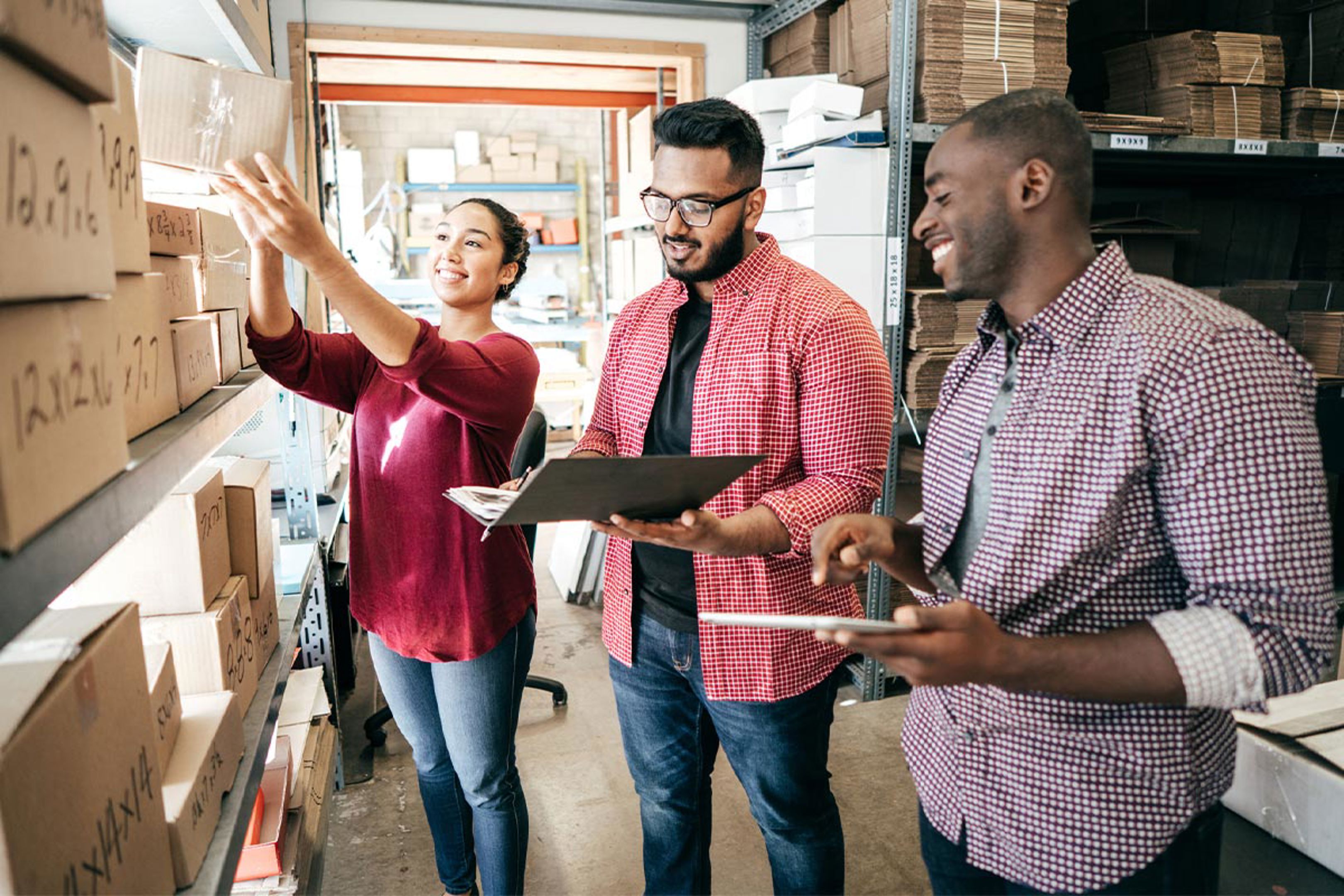 3 People Looking At Boxes