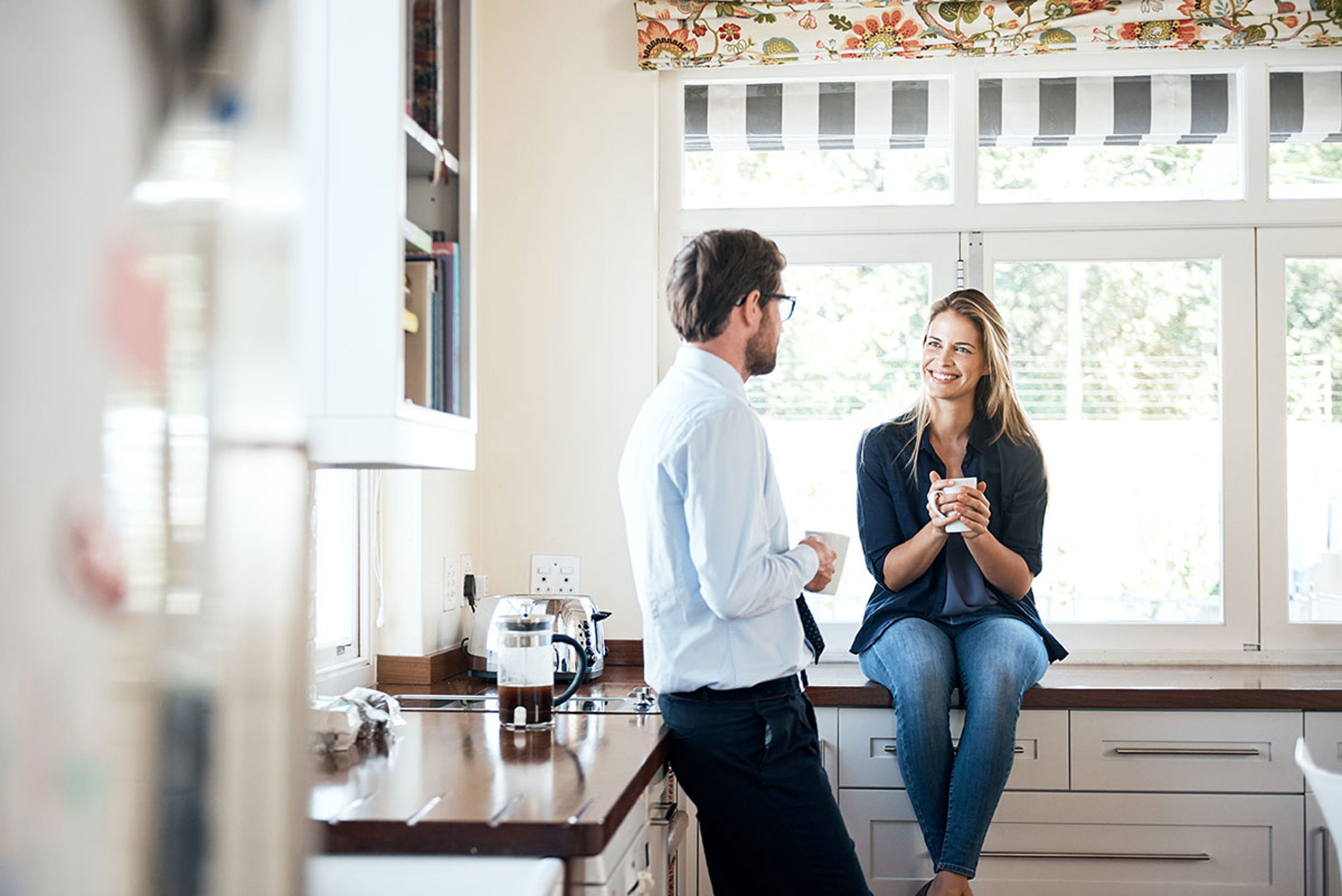 Two People Chatting In A Kitchen