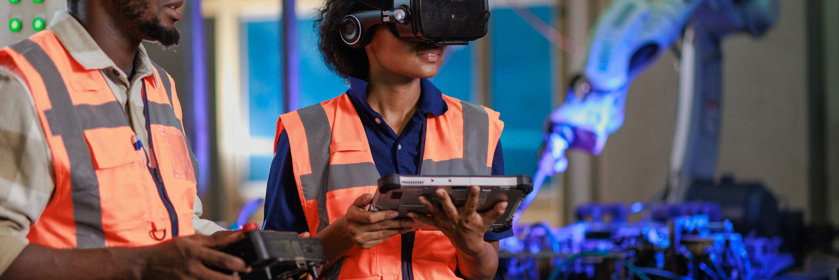 Engineer Using VR Glasses For Controlling A Robotic Welding Arm