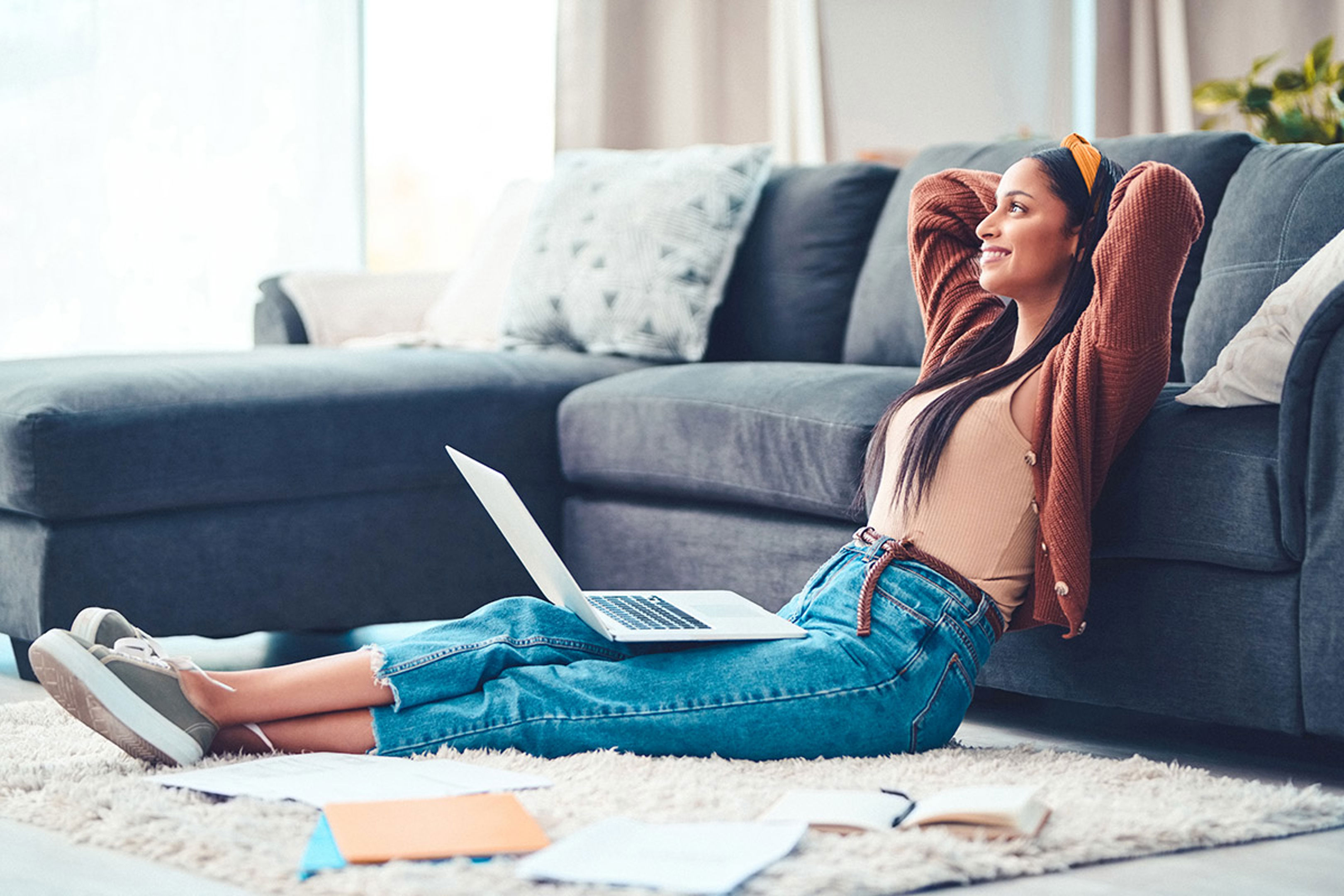Lady On Laptop Leaning Against Sofa