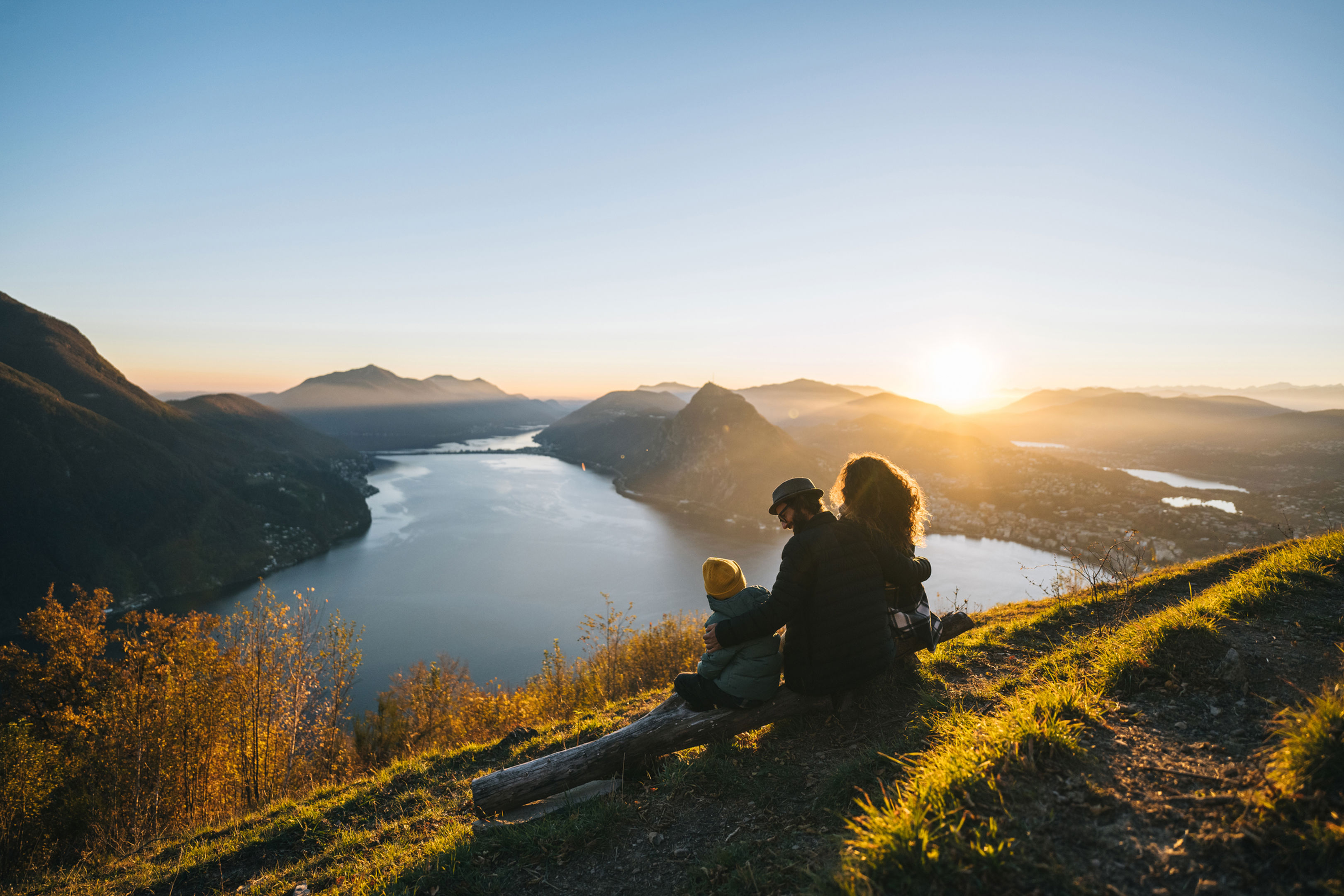 Family looking over water to mountains