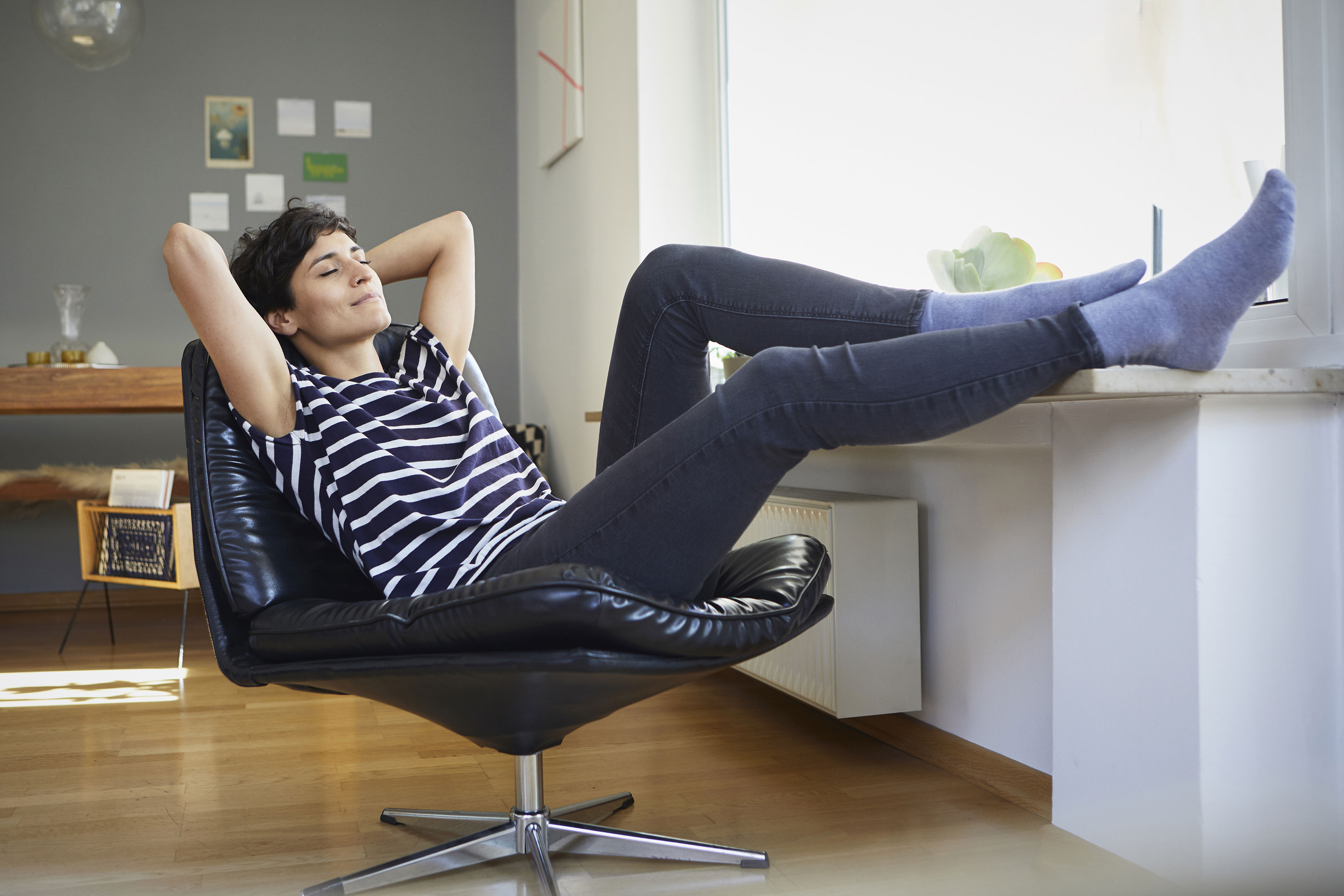 Smiling Woman Sitting At Home Relaxing