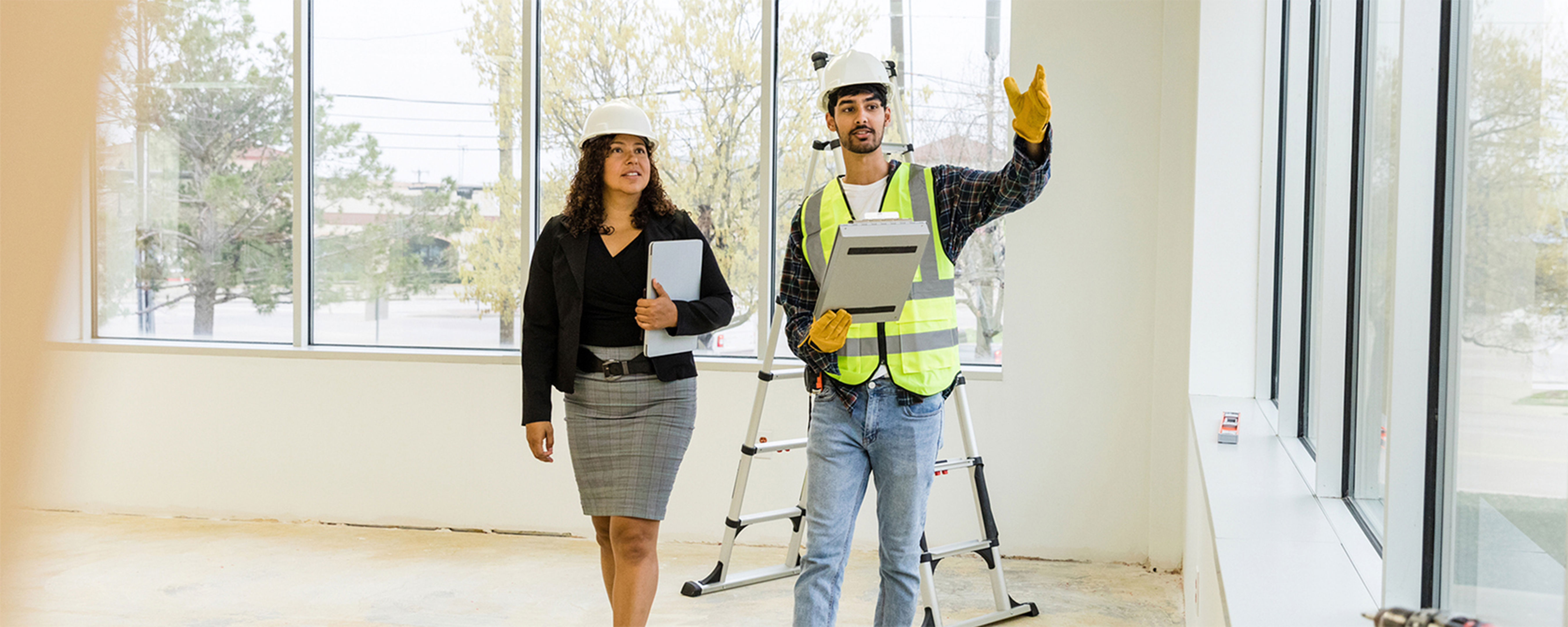 Two workers looking at a refurbishment project in an office