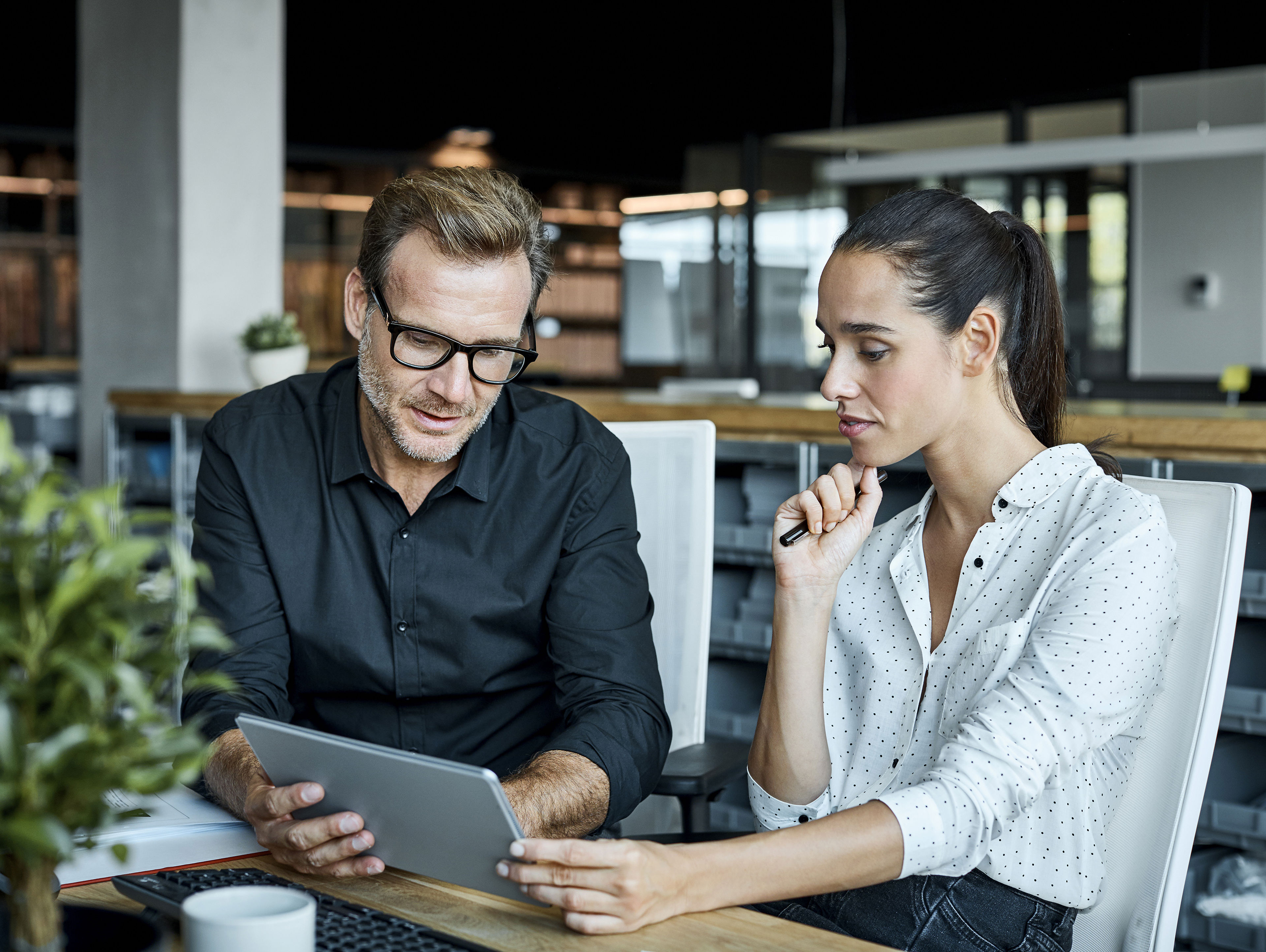 Colleagues Using Tablet PC In Textile Factory