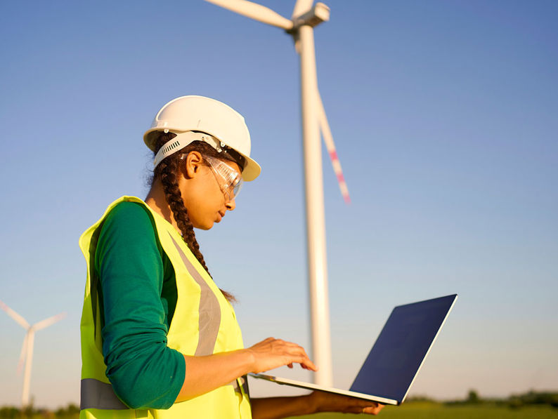 Windfarm with lady working on laptop