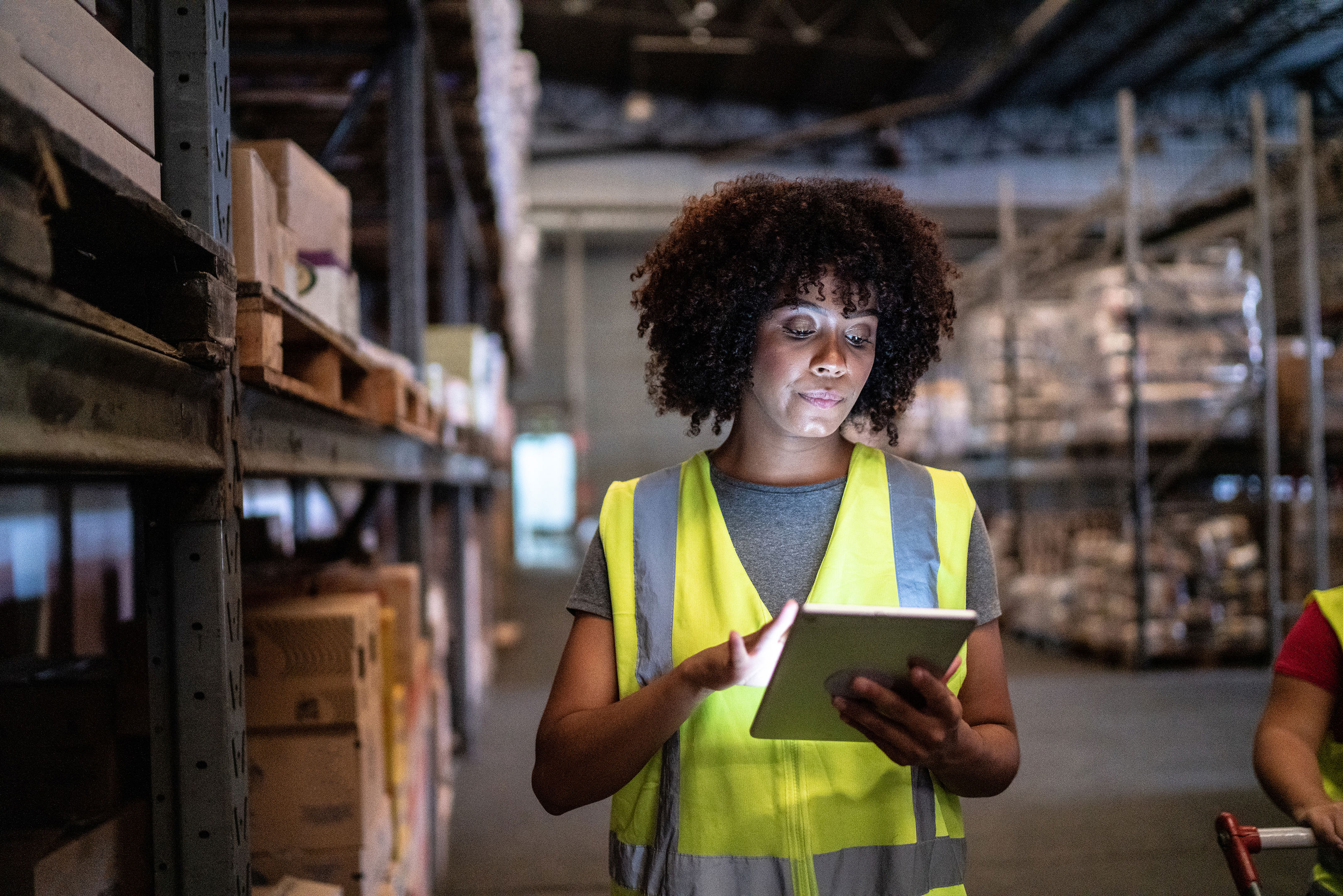 Woman Using The Digital Tablet In A Warehouse