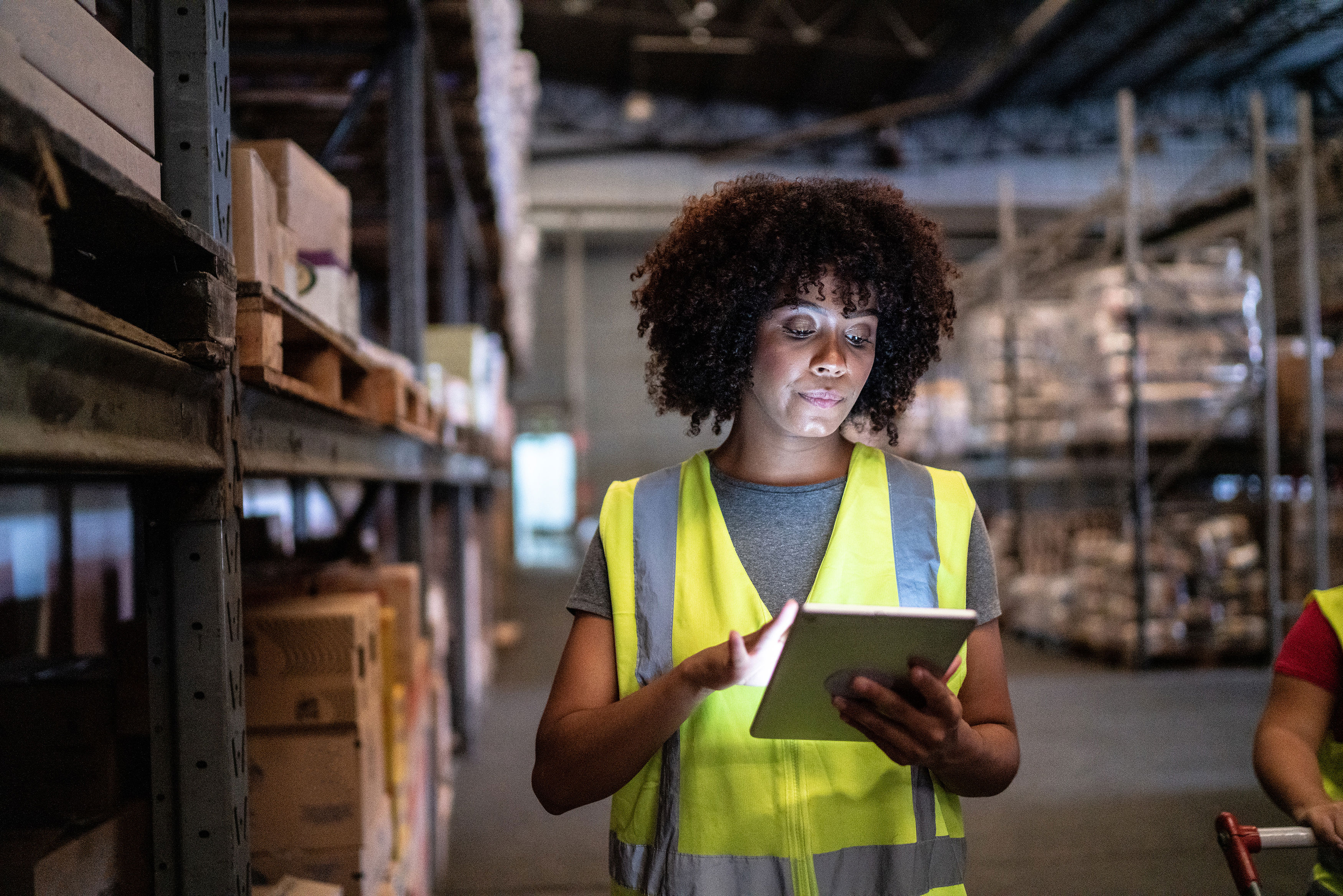 Woman Using The Digital Tablet In A Warehouse