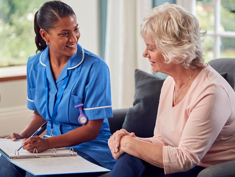 Nurse talking with female patient