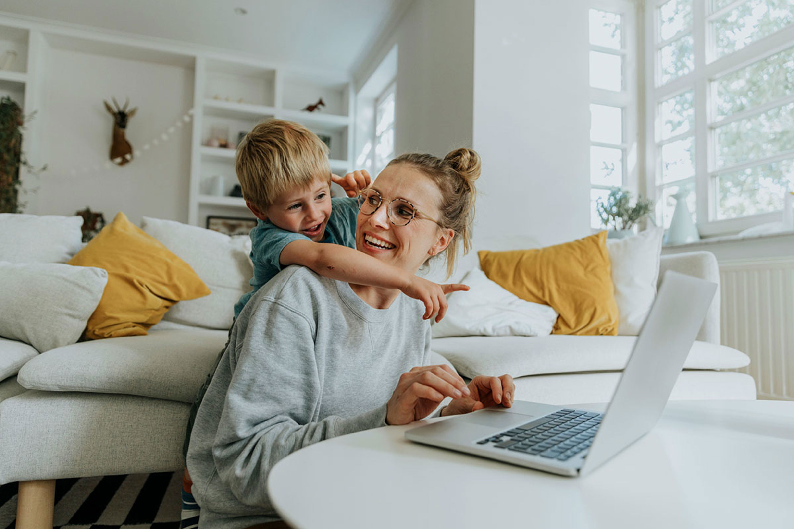 Mum With Blonde Haired Son Pointing At Laptop