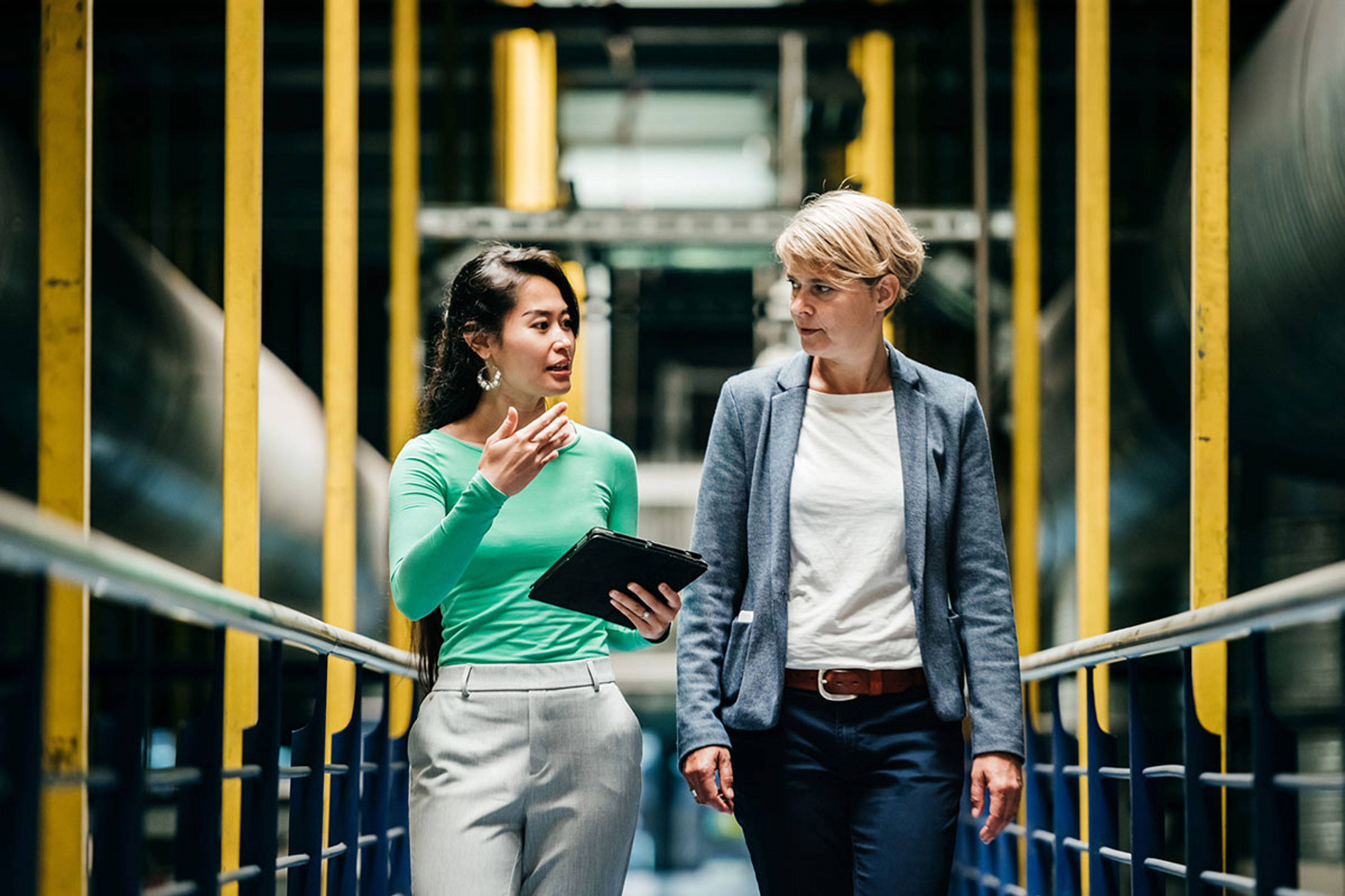 Women walking and talking in corridor