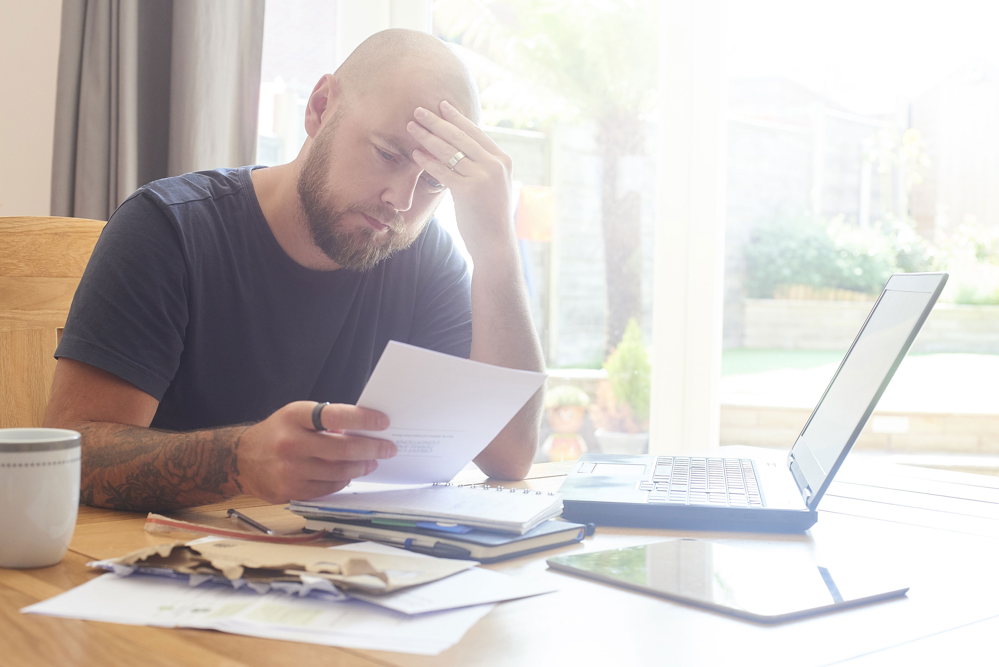 Man Sat At Dining Room Table Working From Home