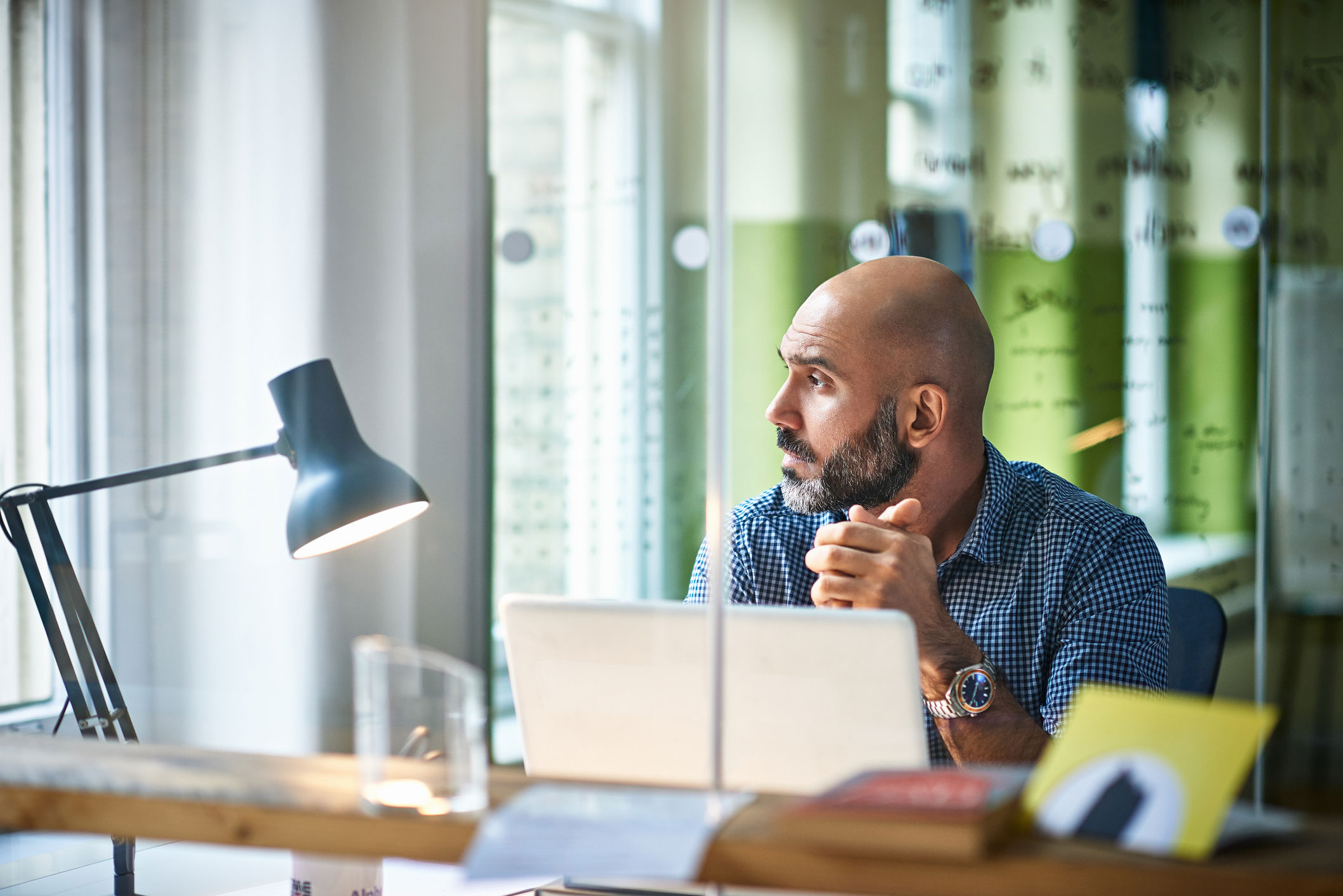 Man With Laptop Looking Out Window