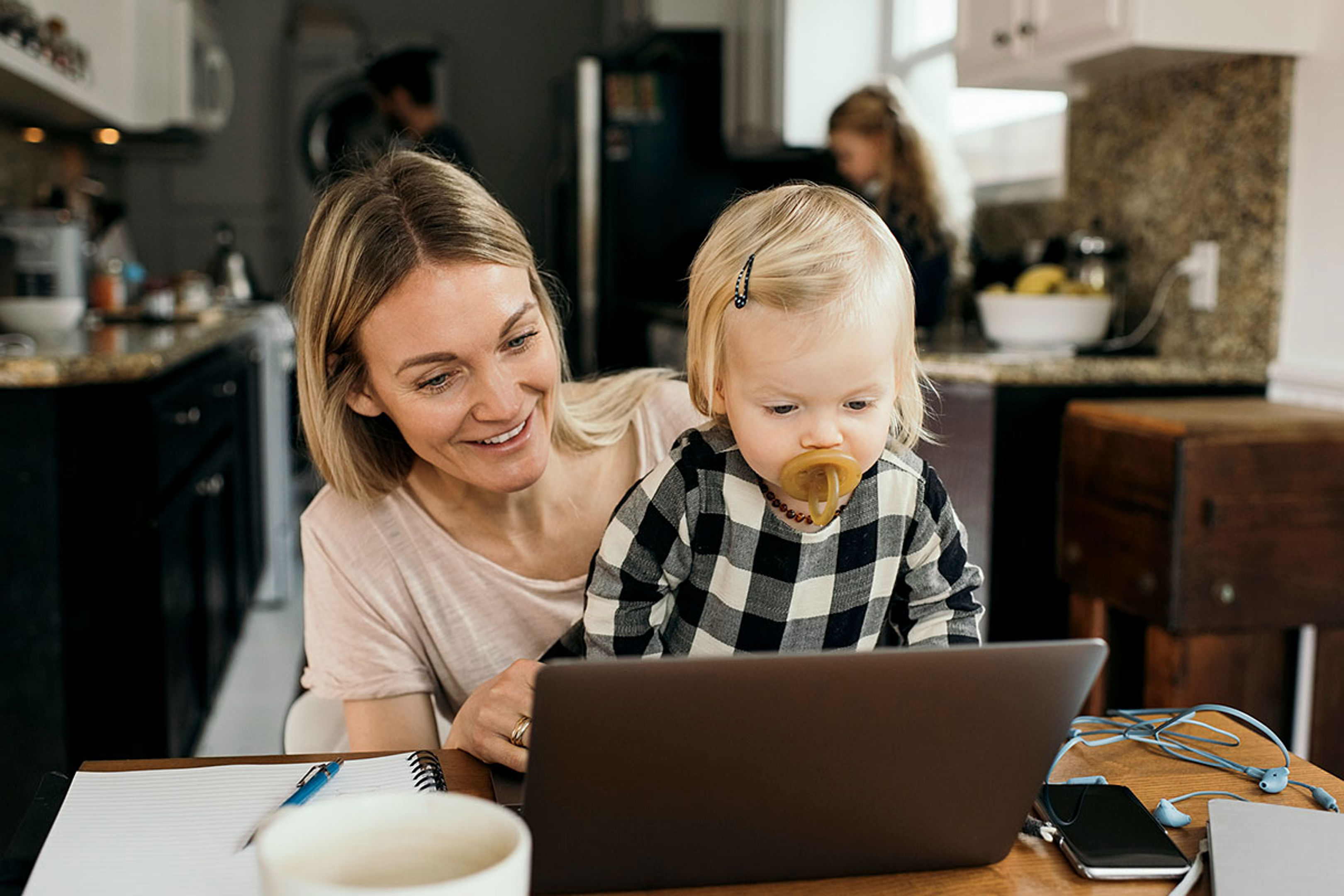Woman And Child Looking At Laptop Together