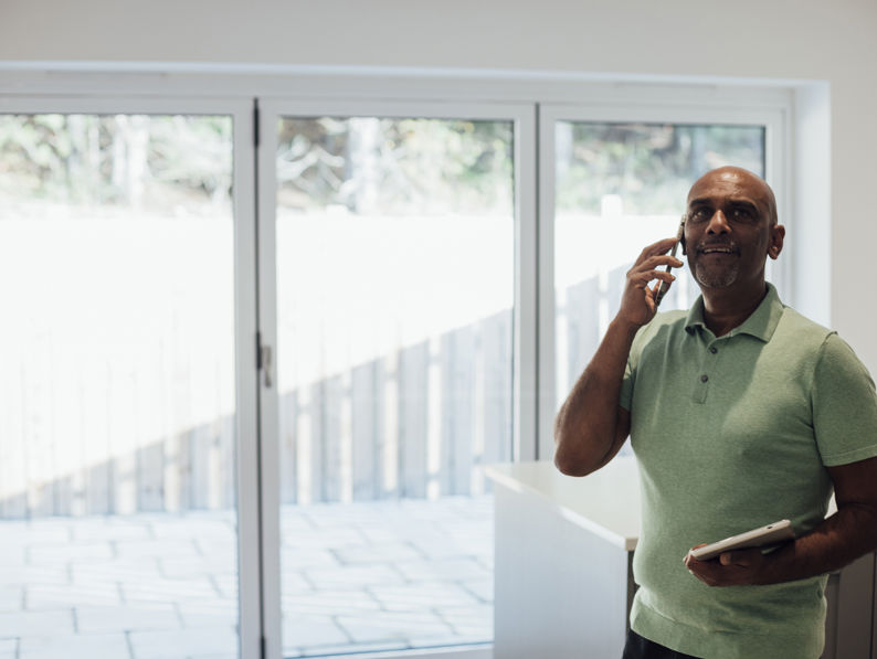 Male Agent Standing In A Home <a href=