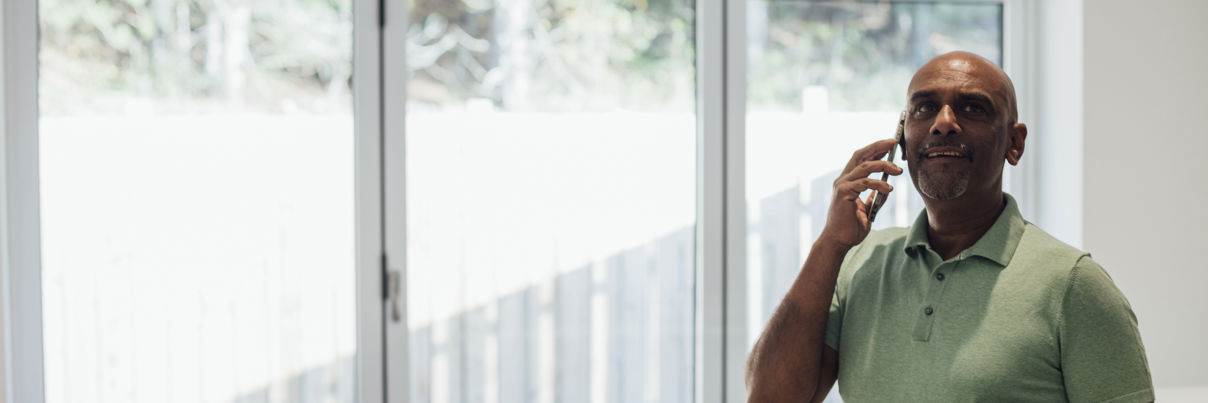 Male Agent Standing In A Home He Is Selling