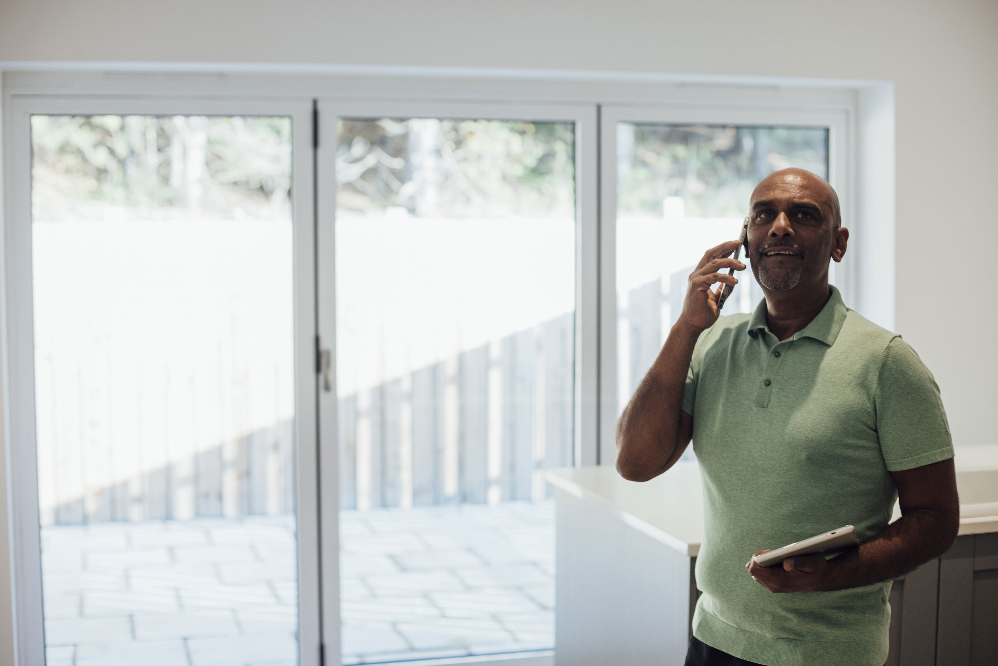 Male Agent Standing In A Home He Is Selling