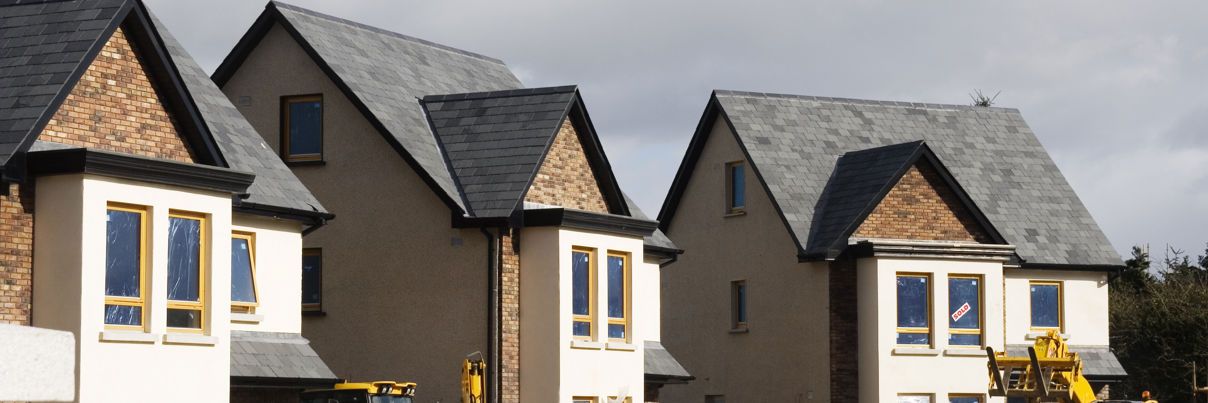 Three detached new build properties during construction.
