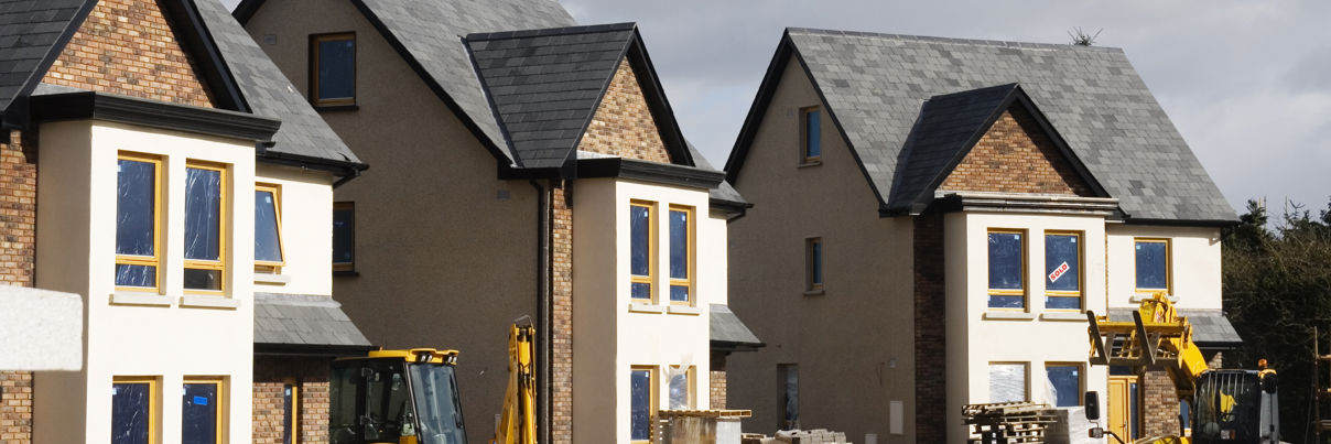 Three detached new build properties during construction.