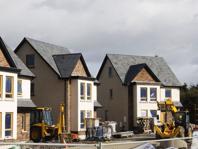 Three detached new build properties during construction.
