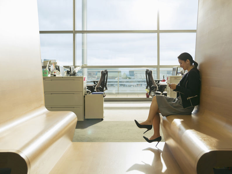Businesswoman Text Messaging In Office