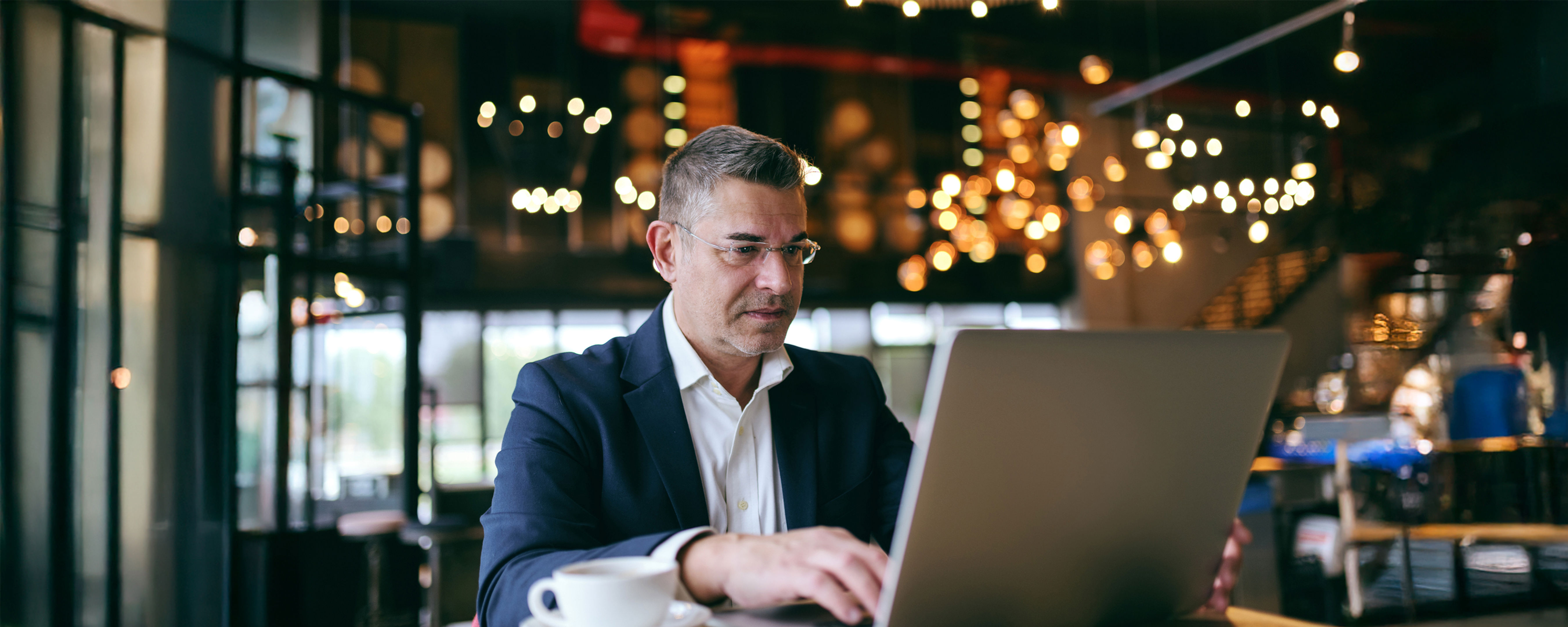 A man in a suit using a laptop.