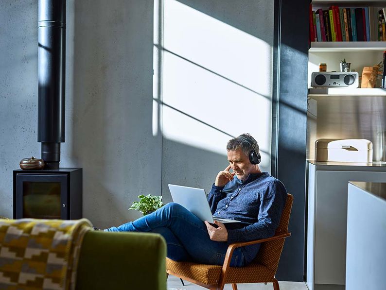 Man On Laptop With Headphones