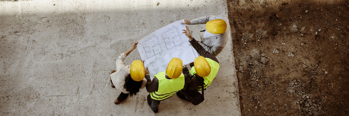 Architects And Engineer With Blueprints
