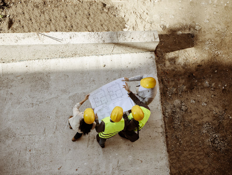 Architects And Engineer With Blueprints